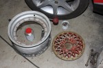 One front wheel disassembled and a failed attempt at stripping the paint off them.